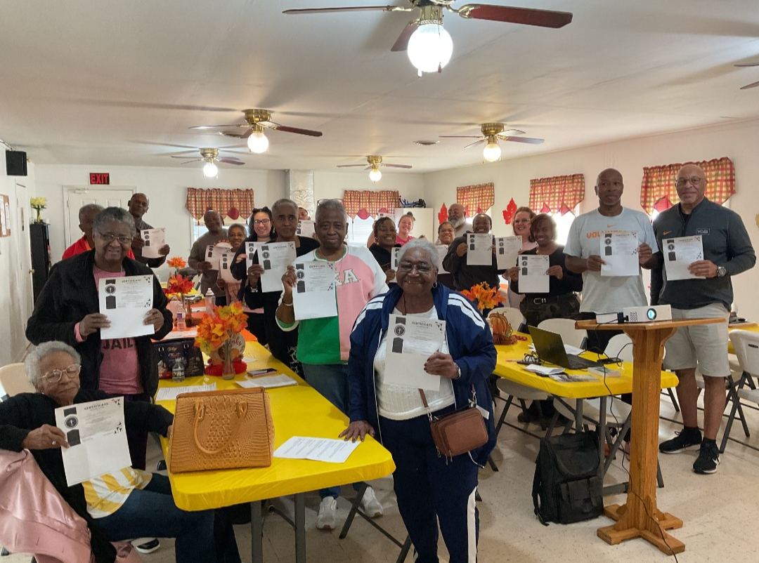 Faith community members holding training completion certificates